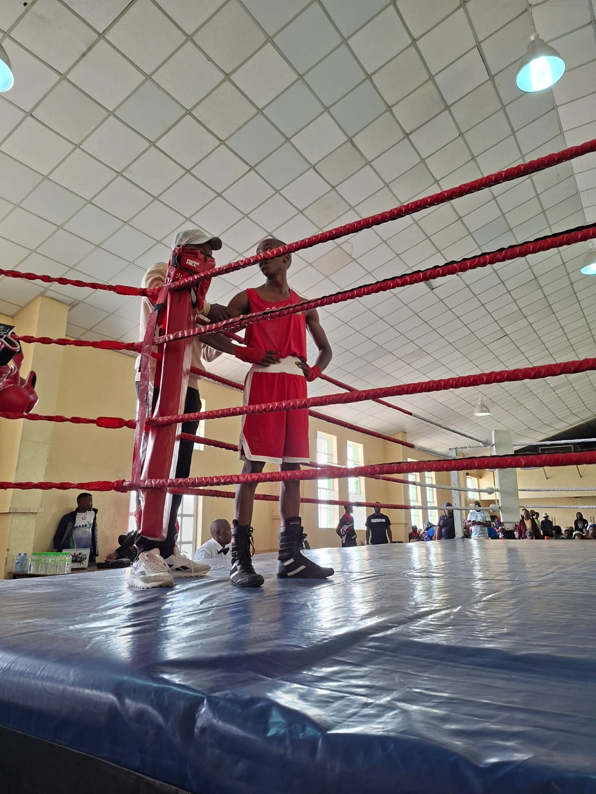 A boxer and coach representing the journey from community training to the ring